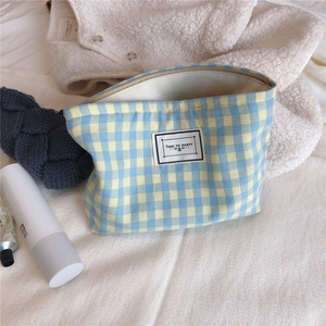 Detail of blue and yellow checkered cotton makeup bag with Time to Party woven label