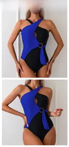 Detail of color-block swimsuit featuring one-shoulder cutout and golden ring belt buckle