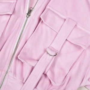 Detail of pink velvet hoodie showing cargo pocket, decorative strap and metal D-ring buckle