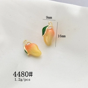 Macro shot of mango-shaped alloy charms with 9mm x 16mm size and weight details