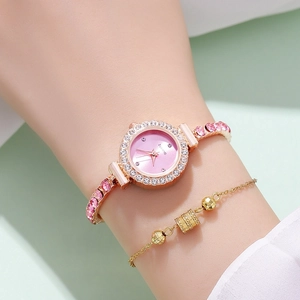 Detail of rose gold watch with pink dial and matching jewelry bracelet on a woman's wrist