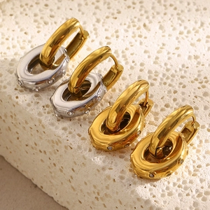 Macro shot of two-tone gold and silver interlocking hoop earrings with inlaid zircons