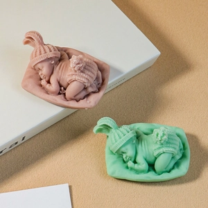 Detailed silicone mold showing sleeping baby with knitted hat and floral texture