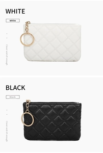 Detail view of quilted PU leather coin purses in black and white with gold zippers