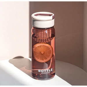 Detail of portable tea infuser bottle with built-in filter and white carrying handle