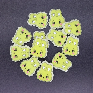 Close-up of cute lime green plastic rabbit DIY charms for phone case decoration