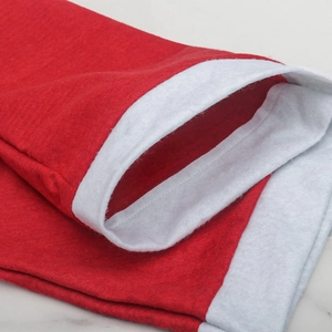 Detailed view of the sewing and soft velvet texture of the red and white festive chair cover