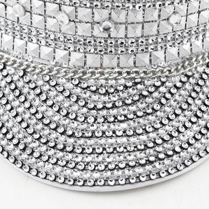 Detailed close-up of sparkling silver rhinestones and metal studs on the sailor hat