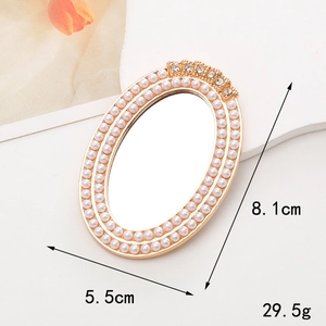 Detailed view of gold oval mirror with pearls and dimensions 8.1cm by 5.5cm