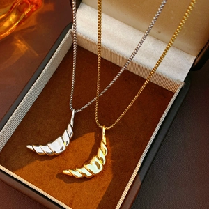 Macro shot of gold and silver croissant moon necklaces in a velvet jewelry box