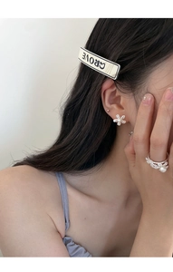 Close-up of pearl flower jewelry set featuring a ring, stud earrings and grove hair clip