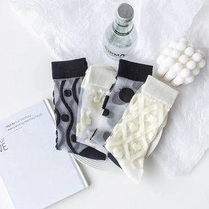 Set of four sheer mesh crew socks with chic black, white, and grey patterns for women
