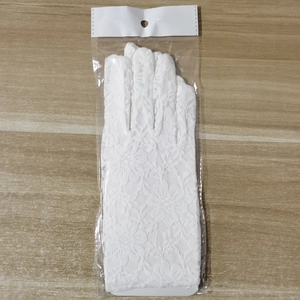 White floral lace bridal wedding gloves presented in transparent packaging on wood