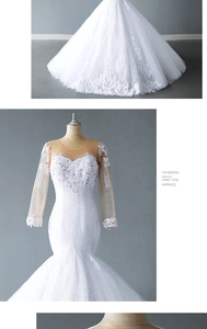 Detail of white mermaid wedding dress featuring sheer lace sleeves and intricate embroidery