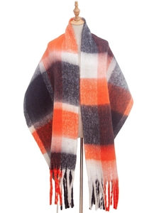 Close-up of thick plaid scarf featuring orange and grey patterns with long fringes