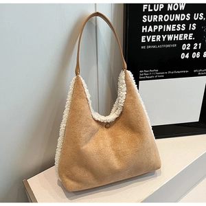 Detail view of khaki faux suede tote bag featuring white faux fur trim and snap button closure