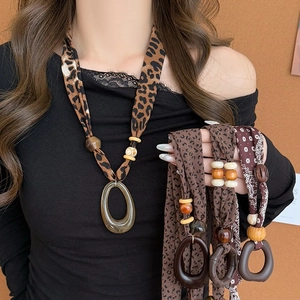 Ethnic bohemian pendant necklace with leopard print fabric beads and wood accents