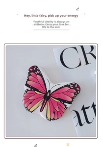 Close-up of cute butterfly-shaped portable pocket mirror with pink and yellow gradient wing pattern