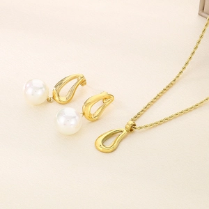 Macro detail of the gold-plated drop design on a pearl necklace and earrings set