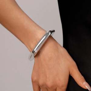 Polished silver irregular geometric cuff bracelet featuring a minimalist mirror finish