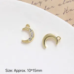 Macro detail of crescent moon gold charms with 10x15mm size dimensions for DIY jewelry