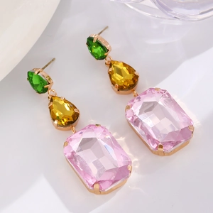 Detailed macro view of triple-layered teardrop earrings with colorful faceted gemstones