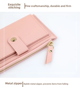 Macro view of pink leather wallet showing fine stitching and gold metal zipper detail