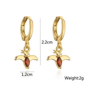 Detailed size view of golden dinosaur earrings with red zircon and 2.2cm length