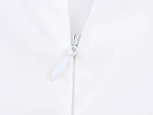 Detailed close-up of a high-quality invisible zipper on a white summer maxi dress