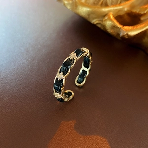 Dettaglio dell'anello a catena in pelle placcato oro con stella in zircone lucente