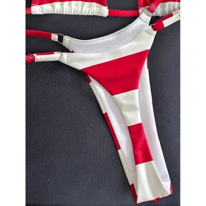 Detail of red and white striped bikini bottom with silver ring and side tie closure