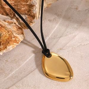 Polished gold organic water drop pendant necklace on a slim black cord with stone decor