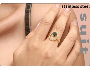 Macro detail of adjustable gold-plated stainless steel ring with green oval gemstone