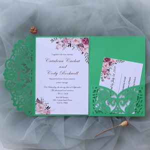 Detail showing green laser-cut wedding invitation set with pink watercolor floral design