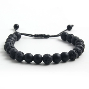 Detail of adjustable tiger eye and lava stone beaded bracelet with woven cord