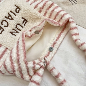 Close-up of pink striped faux shearling tote with FUN PLACE embroidery and magnetic clasp