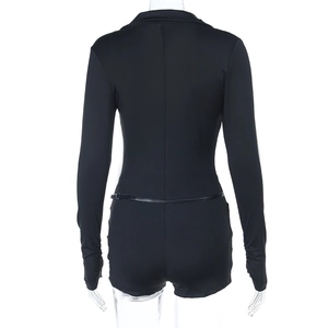 Detail view of the slim-fit back design and stitching on this black long-sleeve bodysuit