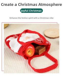 Detail of red knitted Christmas gift bag with plush Santa beard and apple inside
