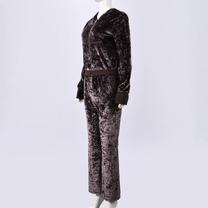 Detail shot of the plush velvet texture on a brown hooded sweatshirt and pants set