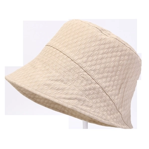 Detail of light beige bucket hat featuring textured seersucker fabric and foldable design