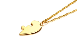 Close-up of golden puzzle piece pendant in polished titanium steel for friendship necklaces
