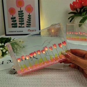Detail of DIY tulip night light with pink flowers in acrylic box and warm LED string light