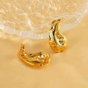 Polished 18K gold plated teardrop stud earrings with hammered texture on gold silk background