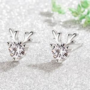 Macro view of reindeer earrings with sparkling round cubic zirconia in silver setting