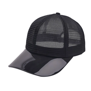 Detail view of black mesh baseball cap with high-gloss patent leather brim and breathable fabric