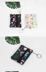 Detail of floral and dinosaur pattern mini coin purses with zipper and metal keychain