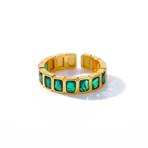 Detail of adjustable gold ring featuring emerald-cut green cubic zirconia stones
