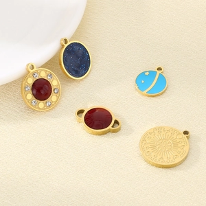 Detailed macro shot of gold stainless steel pendants with micro-pave starry blue stones