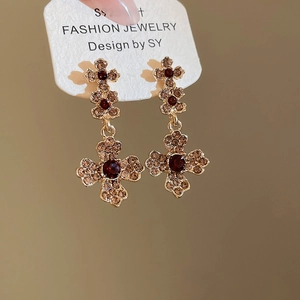 Detail of vintage flower drop earrings with red crystal centers and S925 silver needles