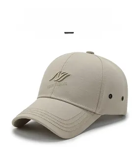 Close-up of beige baseball cap with 3D letter embroidery and metal ventilation eyelets